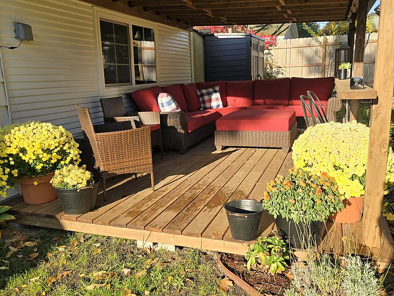 Cozy outdoor seating area w/ remote for Edison type lights.