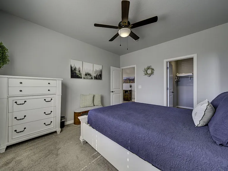 Queen Bedroom
Upstairs bedroom with queen bed, dresser, full-length mirror, and walk-in closet