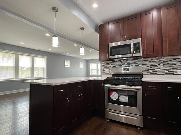 Newly renovated kitchen with 42" express cabinets, brand new stainless steel appliances (including dishwasher), quartz countertops with breakfast bar, and soft-close drawers!