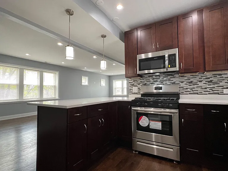 Newly renovated kitchen with 42" express cabinets, brand new stainless steel appliances (including dishwasher), quartz countertops with breakfast bar, and soft-close drawers!