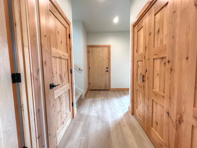 Entry hall. Washer/dryer closet pictured on the right, coat closet and storage on left.