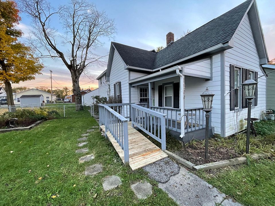 Front of home, including fenced yard and covered porch
