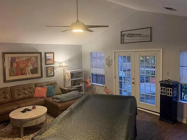 Family room with vaulted ceiling. Doors lead to the backyard.