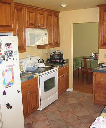 kitchen with tile, newer cabinets and new appliances