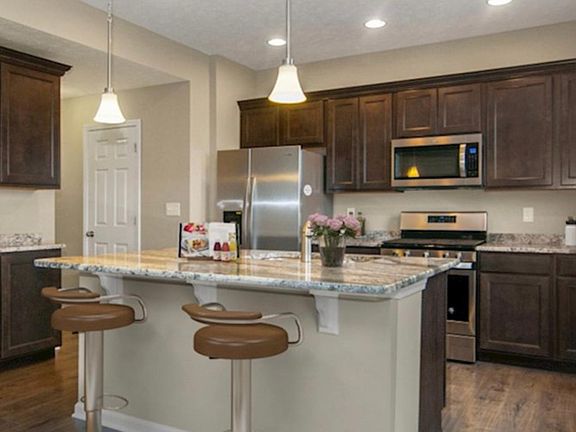 Gourmet kitchen features granite countertops, stainless