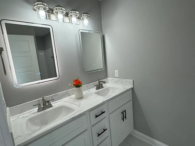 Master bathroom! LED mirrors and beautiful white cabinets.