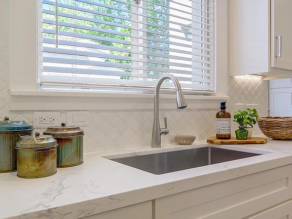 Granite Countertops, S/S Single Basin Sink, Garbage Disposal, Under Counter Lighting and Tile Backsplash