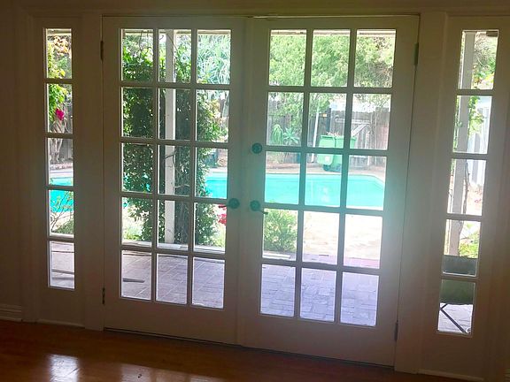 French doors lead out to a covered brick patio