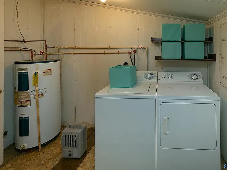 View of the laundry room off the kitchen. The blue bins shown are no longer available.