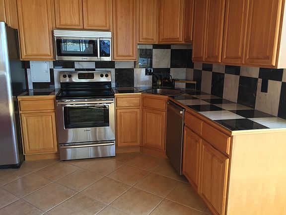 Marble kitchen with newer Bosch and GE Stainless Steel appliances. Kitchen is fully stocked with utensils and cooking appliances. Move in ready.