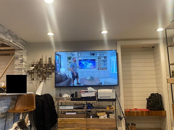 Spacious living room with a floating teak bench & shiplap mud room closet