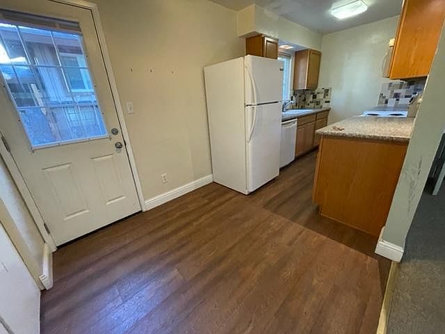 Kitchen and door to backyard (laundry area on left behind closet doors)