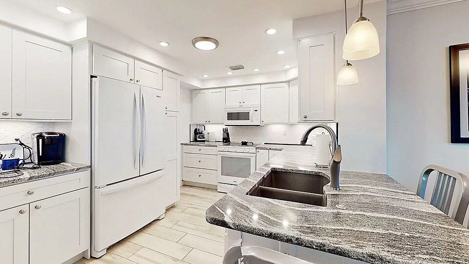 Open modern kitchen with ample storage and cabinets, coffee bar and high end appliances