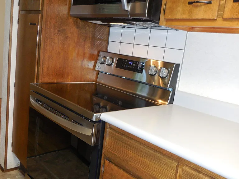 kitchen w/newer stainless steel glass cook-top stove and microwave