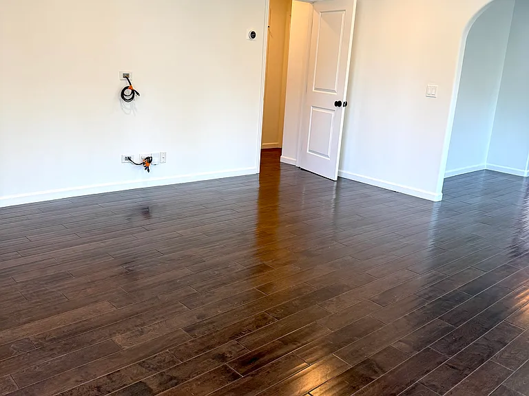 Bright living room filled with natural light, dimmable recessed LED lighting, and pre-wired for TV.