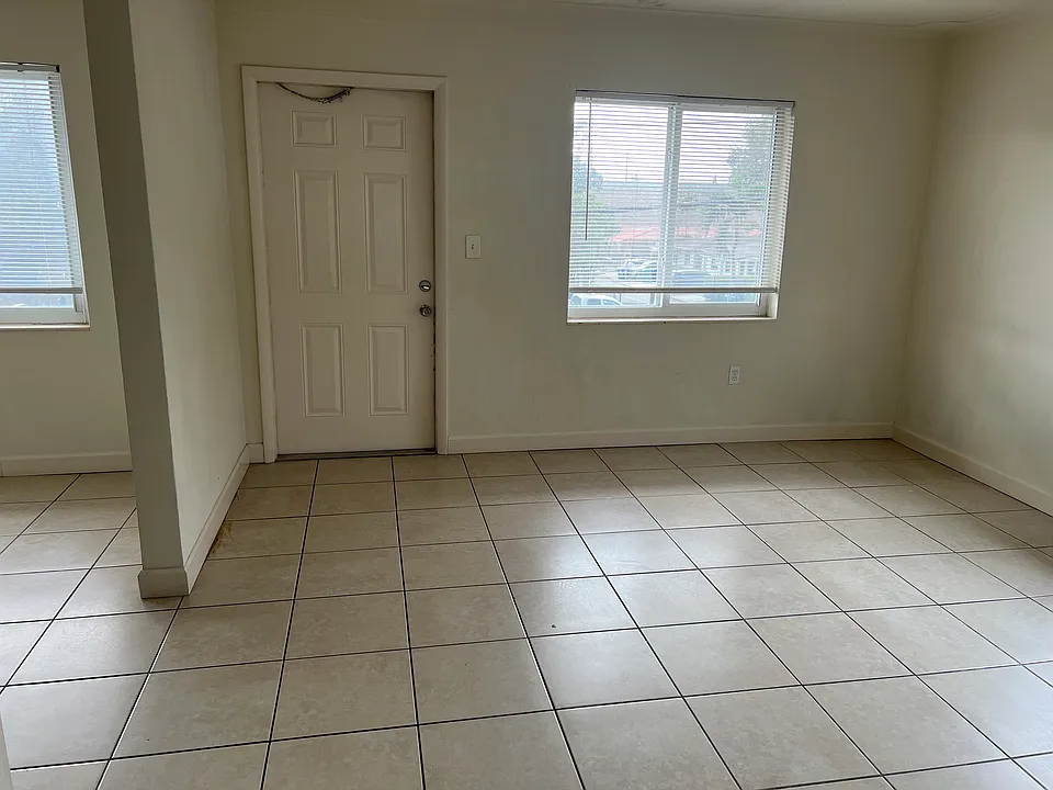 Living room view towards balcony door.