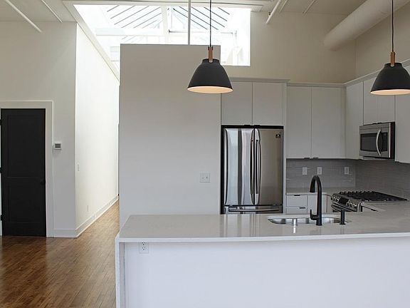 Full kitchen with gas stove, touchless faucet and SS appliances.