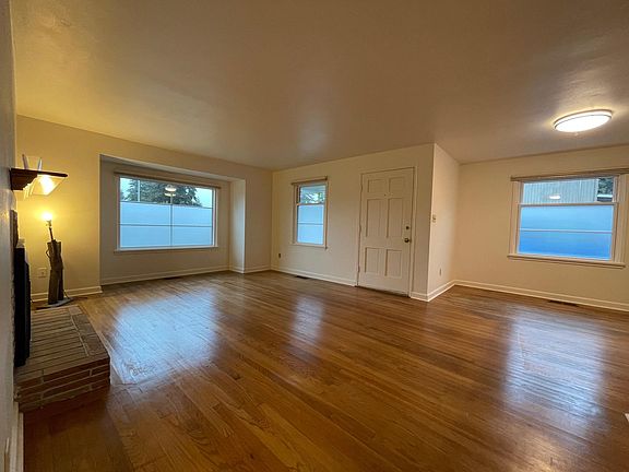 Front door opens to living room with gas fireplace and dining area. Floors will be refurbished as this photo was taken just before move in 2.5 years ago.
