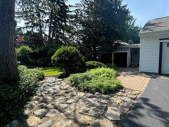 Side yard with garage and shed