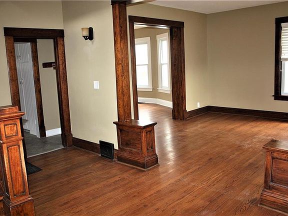 Entry into living room with nice hardwood floors and natural woodwork