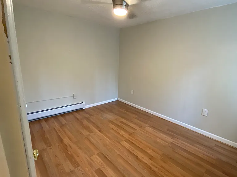 Bedroom with overhead light and fan