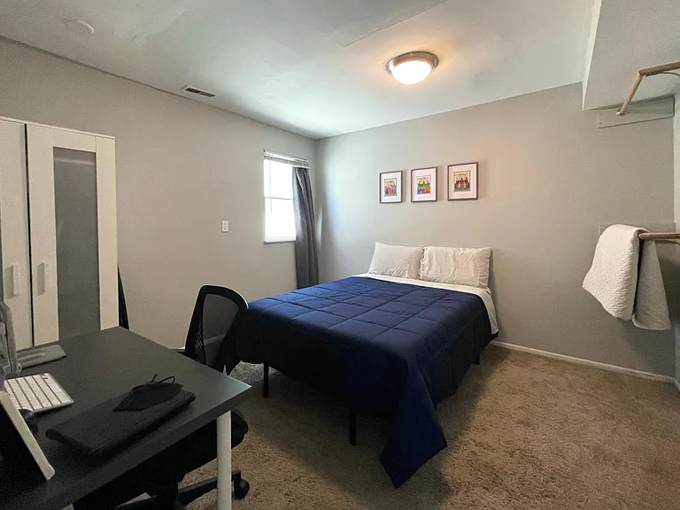 Second bedroom on lower level, featuring workspace and full size memory foam bed