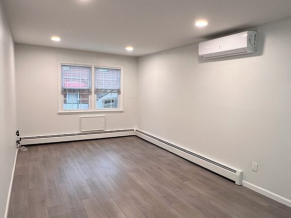 Living room, New Floors and A/C Wall Unit.
