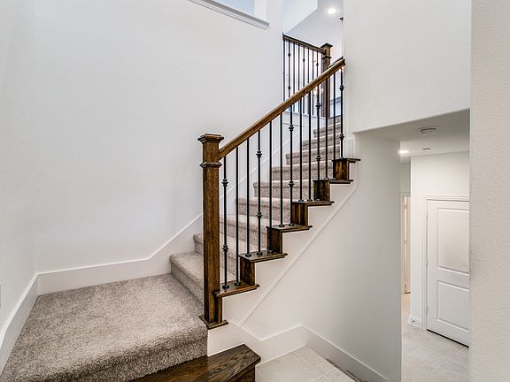Stairway to lower and upper levels from foyer.