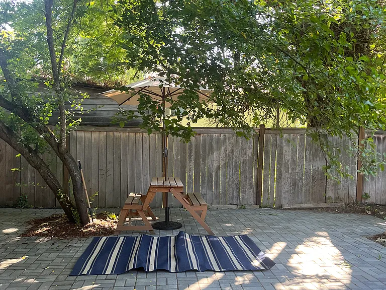 Picnic table and sitting rug on paver patio