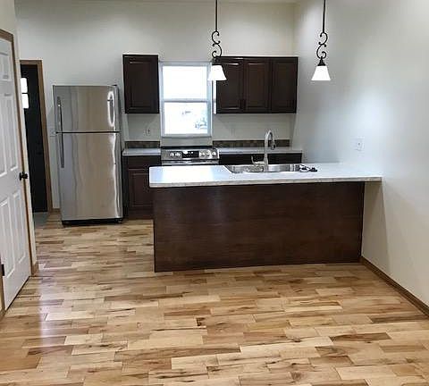 Hardwood floor throughout kitchen, dining room and living room.