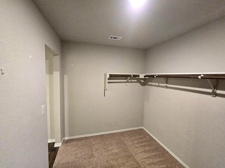 Spacious walk-in closet providing excellent storage capacity.