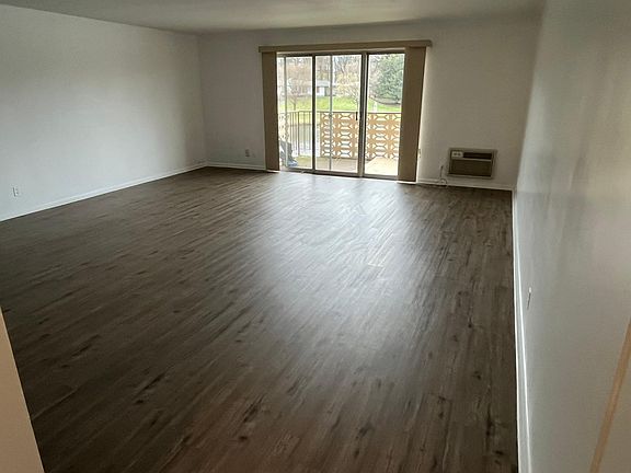 Living room with sliding glass doors out to covered patio overlooking the lake