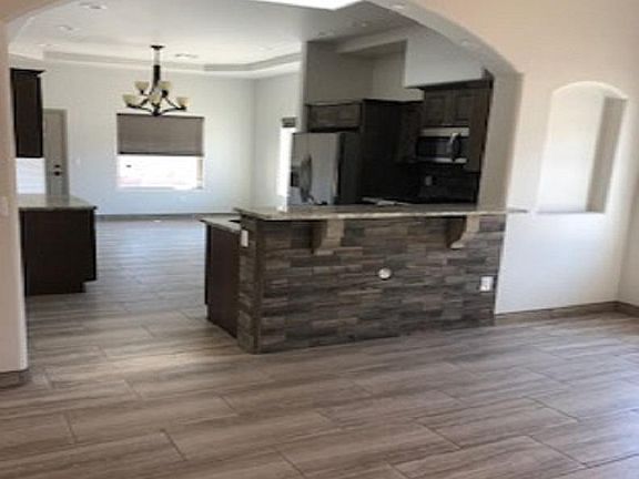 Open Living design w breakfast bar separating kitchen and living room