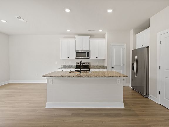 The kitchen has designer wood cabinetry