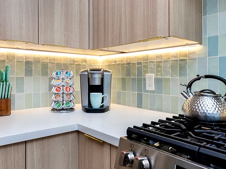 Nespresso and Keurig coffee makers, and a gas range featuring air-fry, slow-cook, and convection settings.