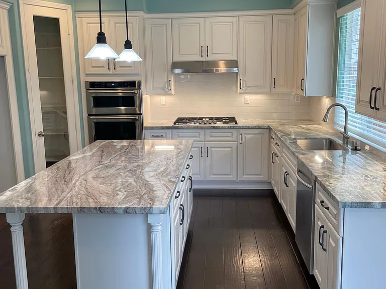 UPDATED KITCHEN WITH SELF CLOSING CABINETS AND GRANITE COUTERTOPS NEW KITCHEN AID OVEN.