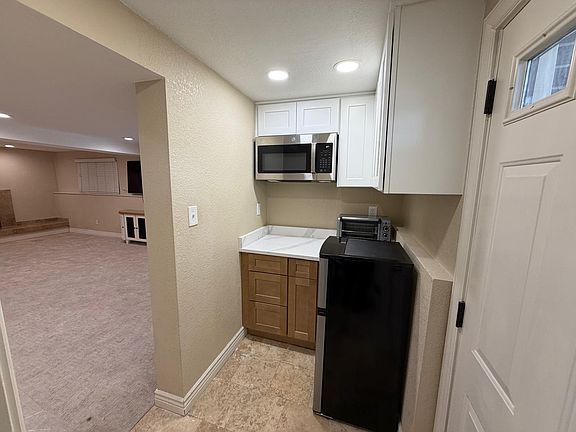 Kitchenette space with stove and counter oven as well as fridge/microwave