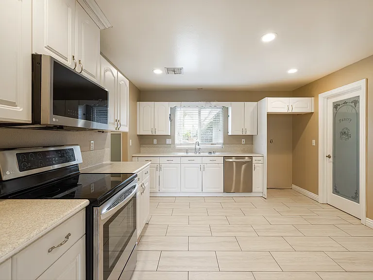 Eat-in kitchen with stainless appliances and recessed lighting