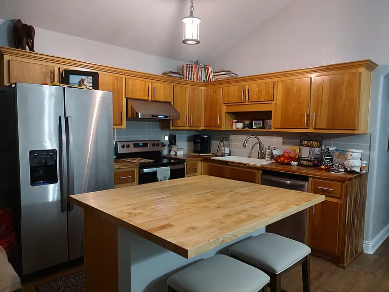 Kitchen updated with tile backsplash, Butcher block countertops and stainless appliances. Kitchen light fixture with dimmer switch. Island has been updated with pullout drawers instead of shelves making it highly functional! Soft close cabinets/drawers.