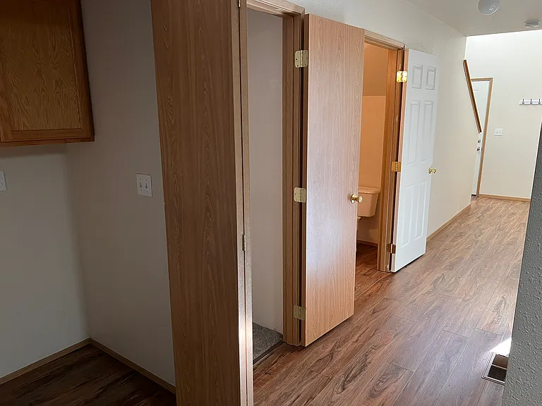 downstairs hall with view of front door and stairs