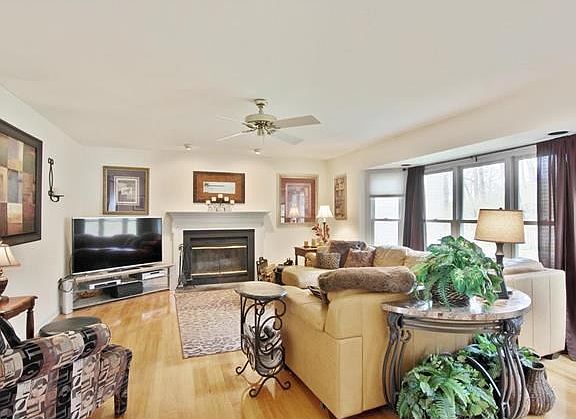 nice big great room complete with bay window, fireplace, hardwood floors and wet bar behind us in this pic