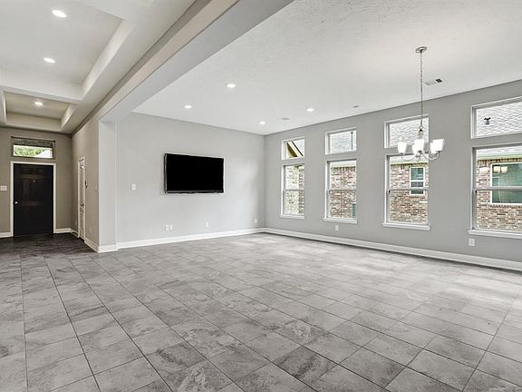 The gorgeous foyer with soaring ceilings leading into the den and formal dining room.