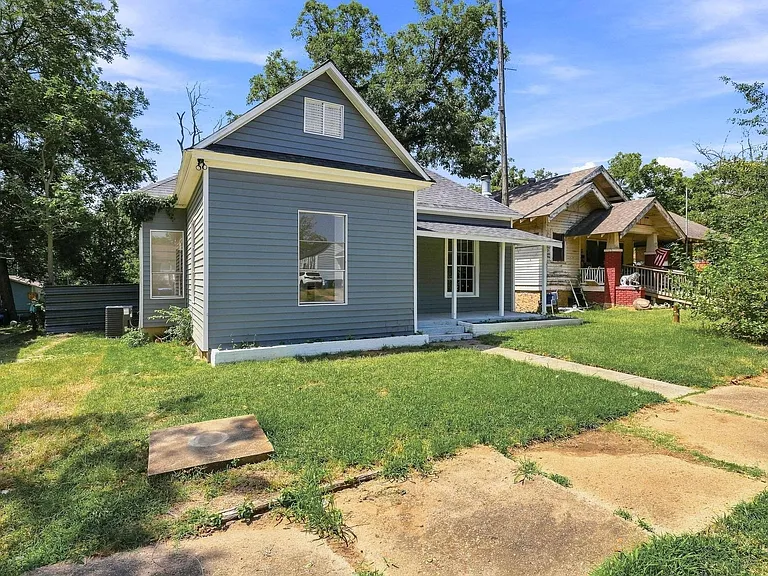 Charming exterior featuring gray siding, white trim, and a covered front porch with white columns