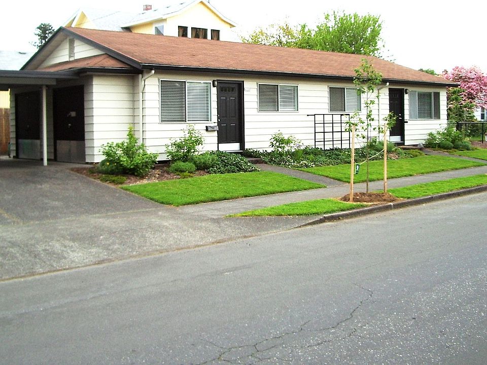 Front with carport and storage rooms on left