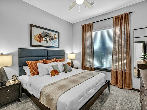 Primary bedroom with carpet and a ceiling fan