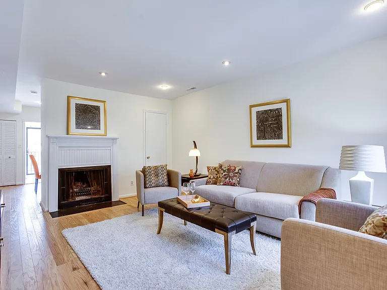 Spacious living room w/coat closet, gleaming hardwood floors and wood-burning fireplace.
