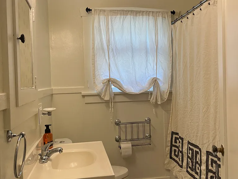 Clean and full size bathroom with bathtub