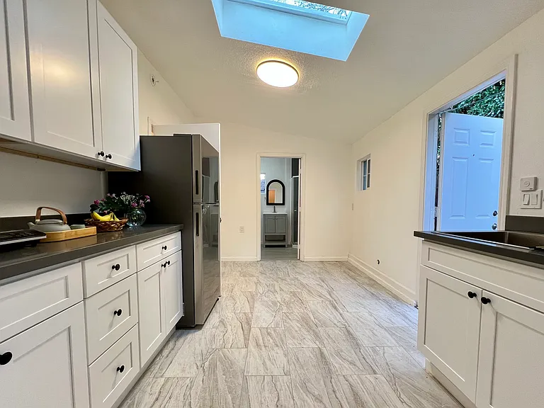 Bright wet bar kitchenette with skylight and new appliances