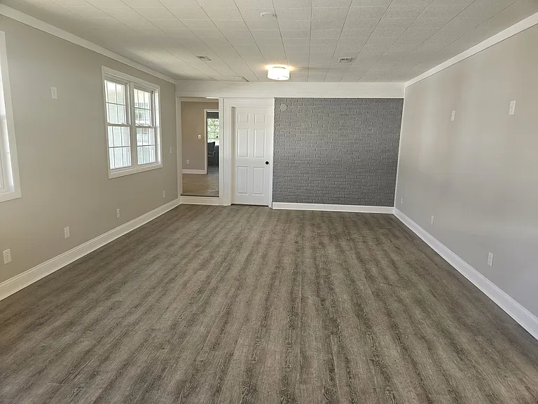 Large family room with lots of natural light toward kitchen and laundry rooms