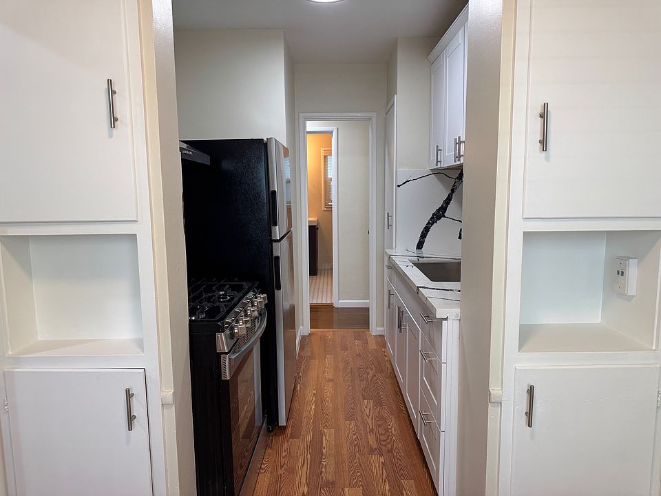 Kitchen from breakfast nook. New: vinyl floor, kitchen sink, countertop and cabinets.